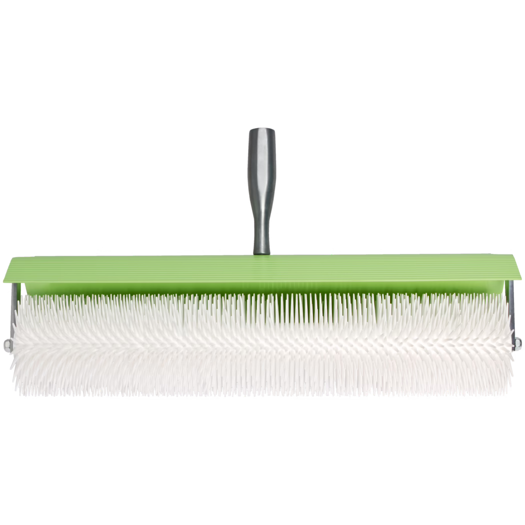 Horizontal product image of a plastic spike roller: a long cylindrical roller densely covered with white flexible plastic spikes, mounted in a green plastic head with a metal frame and a short gray handle, photographed against a clean white background.