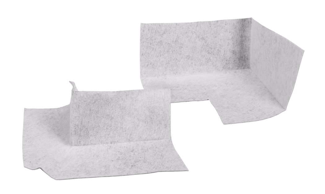 Close-up of overlapping white nonwoven fabric or paper-like sheets with a soft, slightly fibrous texture, arranged against a plain white background.
