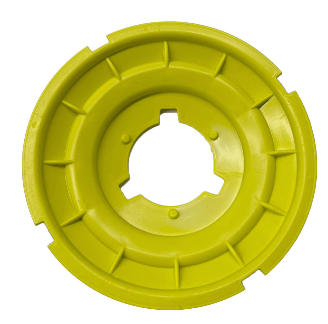 codex_Dummy_BL Balance_2023-06 A bright yellow circular plastic object, resembling a disk, with radial grooves and a central hole. The design features a series of ridges or flanges around the edges, providing grip or fit for some mechanical purpose. The surface appears smooth with a glossy finish, highlighting the vibrant yellow color.